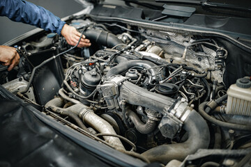 Fototapeta na wymiar Dirty engine under the hood of a car