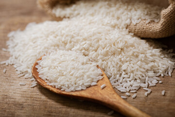 Raw white rice on a wooden board