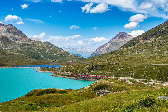 Bernina Express at the White Lake in Ospizio Bernina, Engadin, Switzerland
