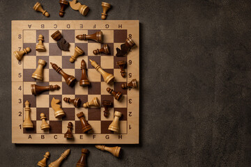 Chess pieces are scattered chaotically on a chessboard