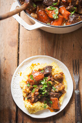 Boeuf bourguignon with carrots, mushrooms, topped with parsley served with polenta 