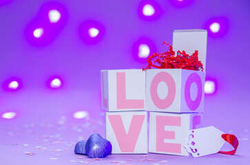 Boxes with love on the background of lights, pink love. Candy and gifts to your loved ones.
