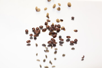 Falling coffee beans. White background.