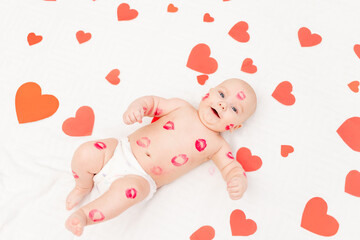 baby among hearts and with kisses from red lipstick, the concept of love and Valentine's day