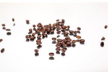 Falling coffee beans. White background.