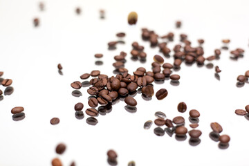 Falling coffee beans. White background.
