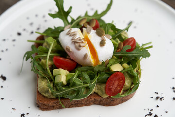 Poached egg toast with guacamole avocado sauce.