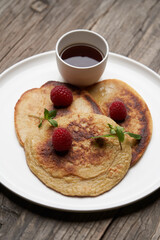 Healthy oat pancakes with raspberry berries and honey syrup