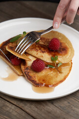 Healthy oat pancakes with raspberry berries and honey syrup