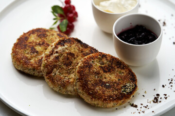 Cottage cheese pancakes with berry jam and sour cream