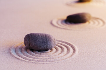 Zen garden stones on sand with ornament