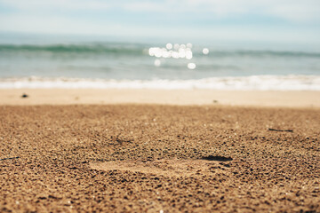 Foot prints on a sandy beach. Beach travel, vocation concept.