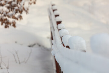 Iron fence covered with snow in winter