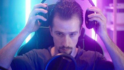 Professional gamer get ready for online gaming put on headphones 4K