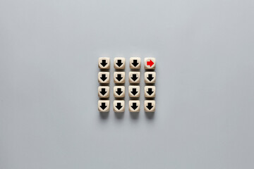 Wooden cube with arrow icon moves in a different way against the other cubes.