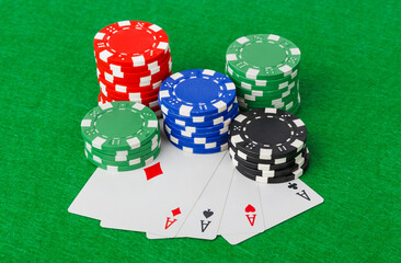 Casino chips and playing cards on green table