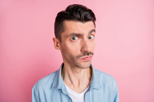 Photo Of Minded Curious Young Man Look Raise Eyebrow Question Isolated On Pastel Pink Color Background