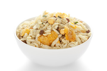 Crunchy Diet Mixture in a white ceramic bowl made with Puffed Rice, Corn Flakes, and Curry leaves. Pile of Indian spicy snacks (Namkeen), under backlight, side view, against the white background.