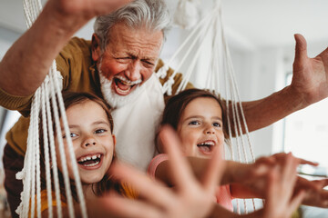 Family, generation love and people concept. Happy grandparent having fun with children at home