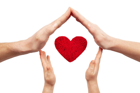 Family love. Hands of parents and child around a red heart isolated on white background.