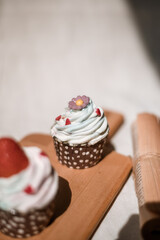 cupcake on wooden chopping board