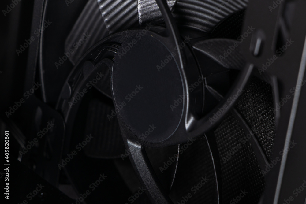 Poster cose up of computer fan on a dark background