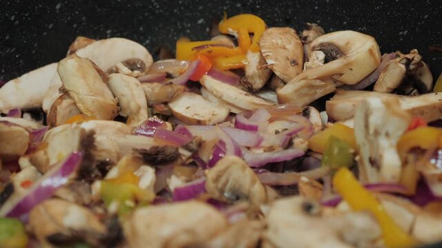 Motion controlled shot of mushrooms in a cooking pan