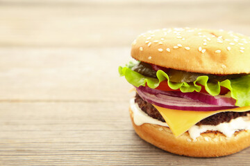Homemade hamburger with vegetables on grey background.
