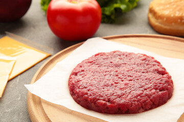 Raw Ground beef meat Burger steak cutlets on wooden table.