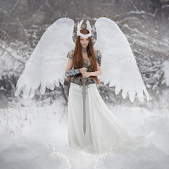 Art photo of an angel woman with white wings and a valkyrie sword