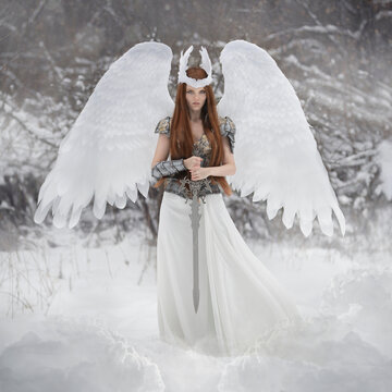 Art photo of an angel woman with white wings and a valkyrie sword