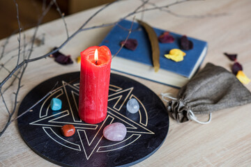 Altar with a pentagram to attract love, happiness, candle, stones, Tarot cards and witchcraft at...