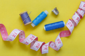 Sewing accessories on a yellow background, flatley.