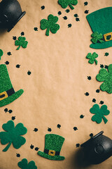 Happy St Patrick's Day concept. Flat lay leprechaun hats, clover shamrock leaves, pots of gold on...