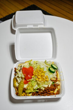 junk food in plastic box on table