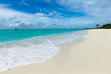 tropical Maldives island with white sandy beach and sea