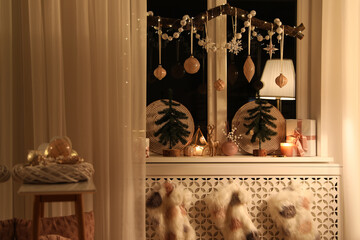 Beautiful room interior with small fir trees in evening. Christmas decor