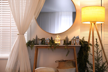 Stylish room interior with mirror and wooden console table near wall