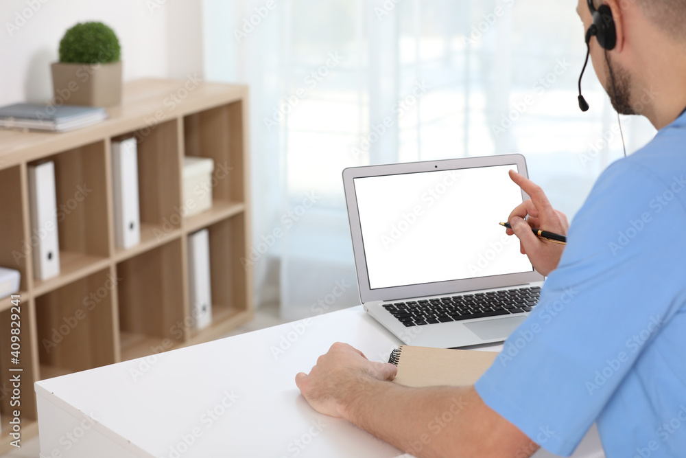 Canvas Prints Doctor with headset consulting patient online at desk in clinic, space for text. Health service hotline