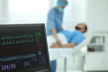 Monitor with cardiogram in hospital, focus on screen. Space for text