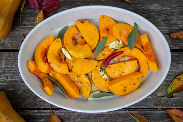 pumpkin with herbs and spices in a baking dish