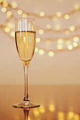 Glass of wine with bokeh background close up. Flat lay. New Year, Christmas mood. Greeting card. Party and holiday celebration concept.