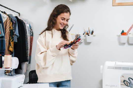 Seamstress Looking At Fabric Samples In The Workshop