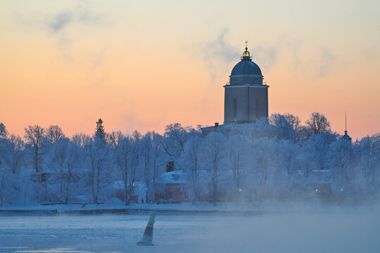 Suomenlinna fortress island on  cold winter morning at sunrise with sea fog and icy Baltic sea. 