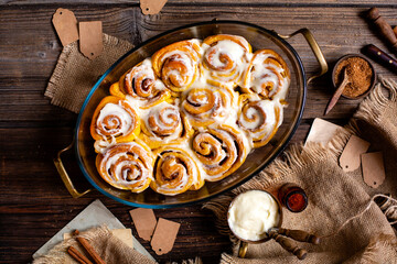 Tasty orange cinnamon swirled buns with white glaze on top