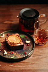 Tea with sweet cake on a wooden table in the restaurant