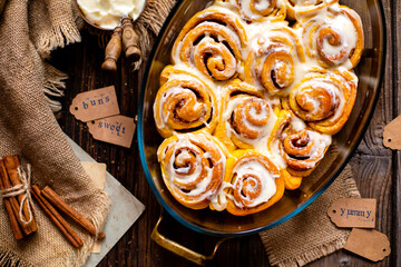 Tasty orange cinnamon swirled buns with white glaze on top