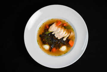 Vegetable soup with quail eggs and herbs