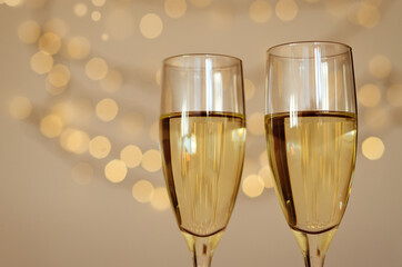 Two glasses of wine with bokeh background close up. Top view. New Year, Christmas mood. Greeting card. Party and holiday celebration concept.