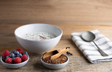 Portion of flax seeds in a small bowl. Healthy super foods flax seeds in a bowl mixed with yoghurt ready to eat. These seed are very healthy and can be eaten with a variety of different dishes.
